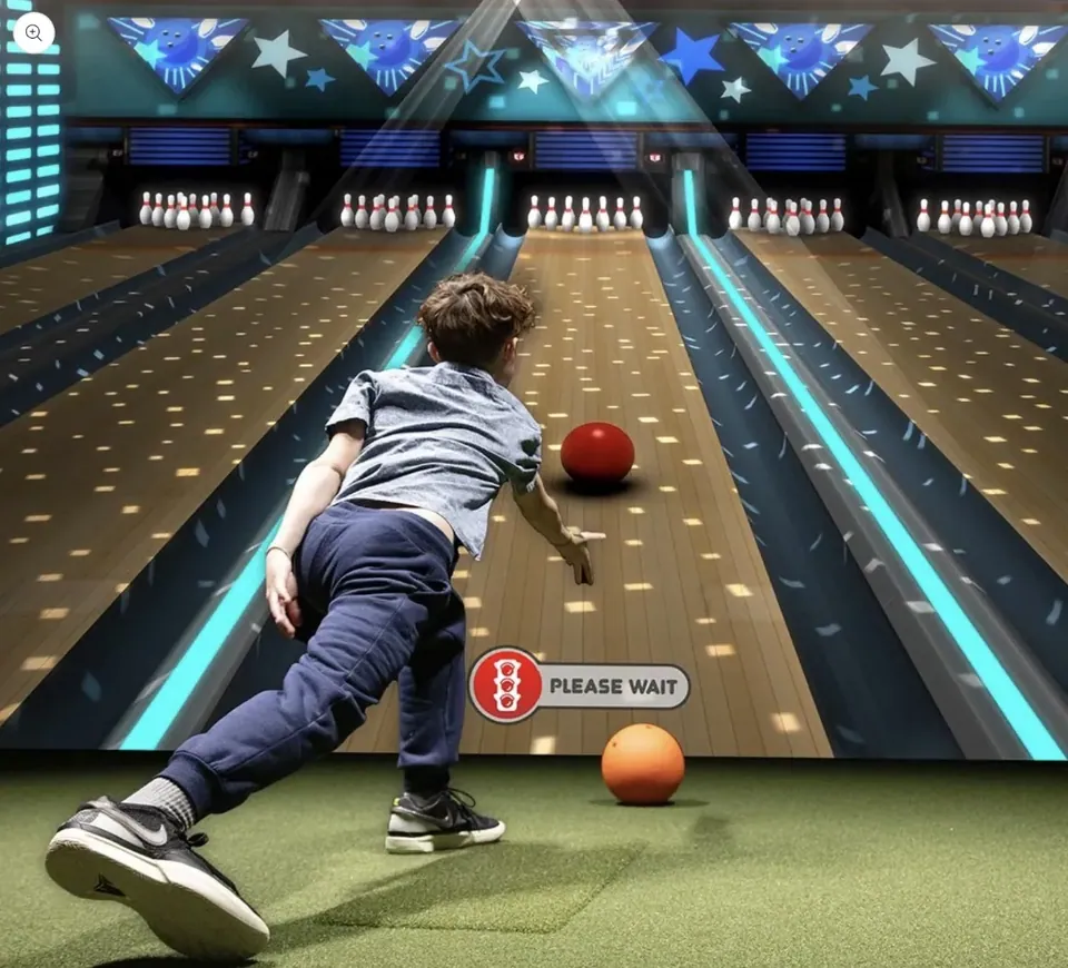 A bowling game projected on the screen