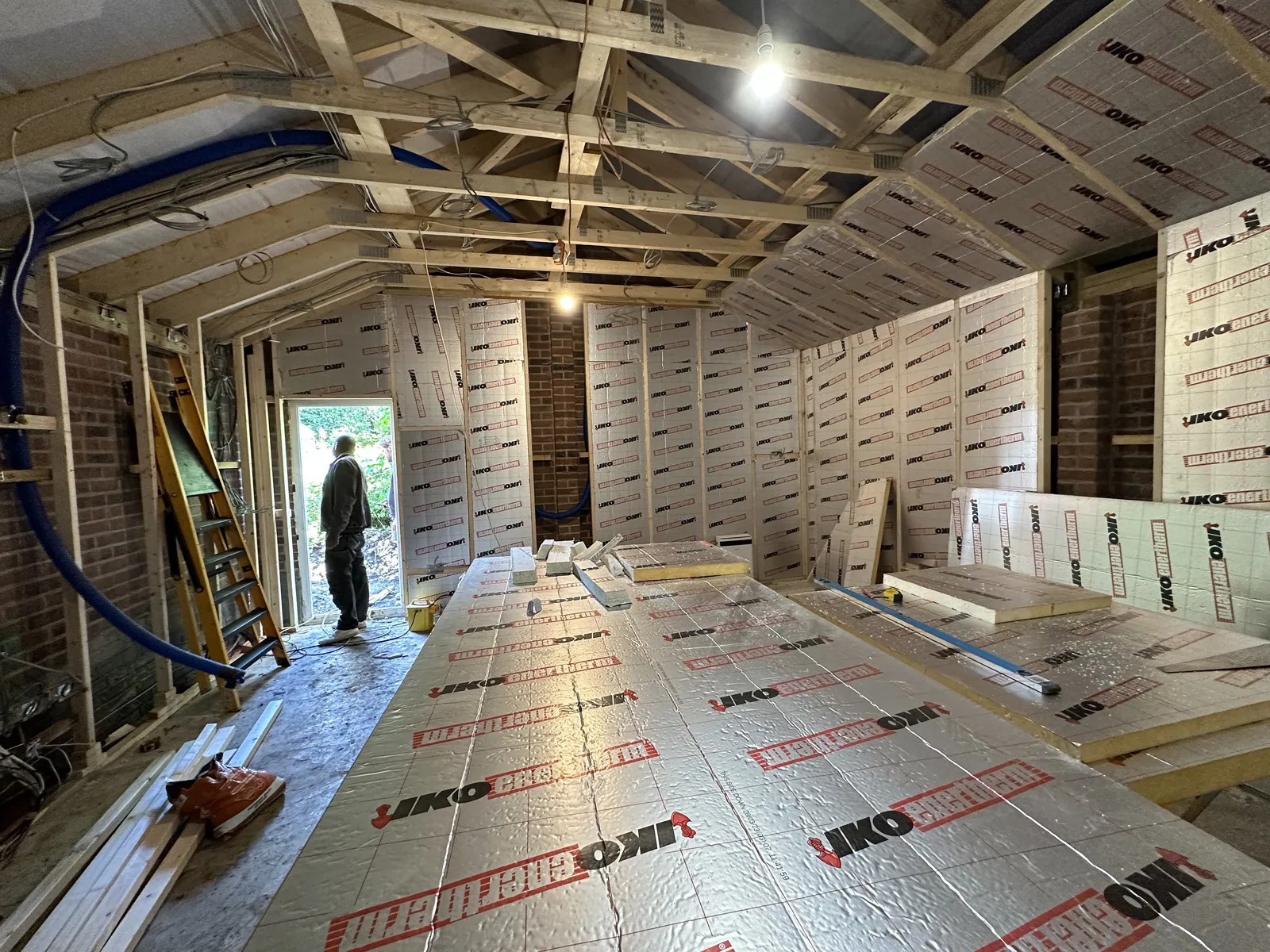 The garage insulated and framed out, with insulation boards on the floor