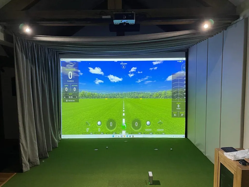 A screen fitted with grey side curtains, with a projector above